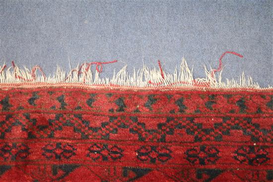 An Afghan red ground rug, 235 x 340cm